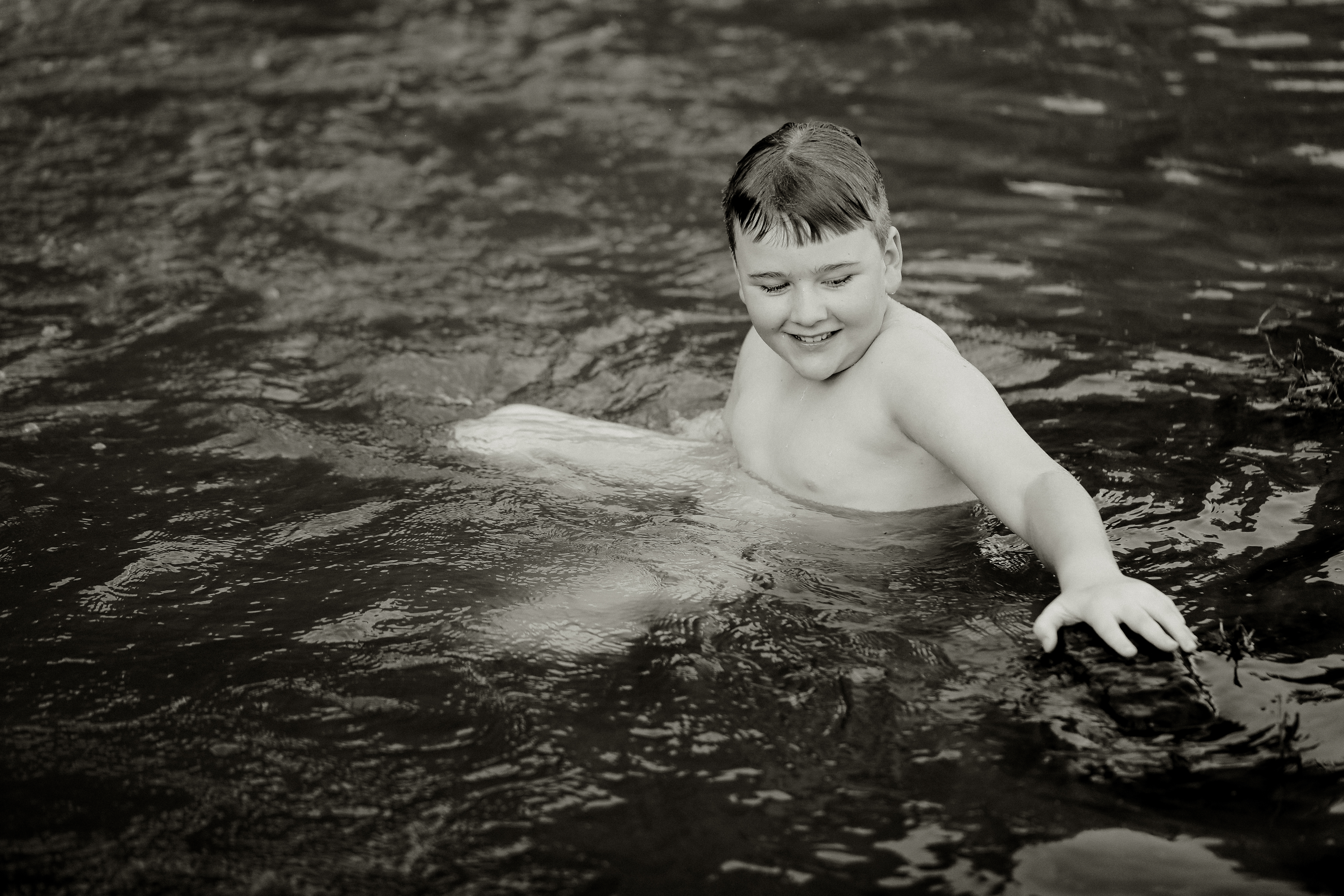 Grayscale Shot Of A Boy Swimming In The Natural Sw 2025 02 02 14 19 20 Utc