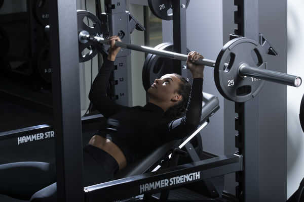 Woman Lifting Bench And Power Rack
